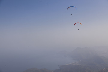 skydivers in the sky, mountains.