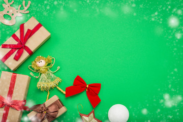 Christmas decorations, Christmas toys and gift boxes on a green background with snow. Concept of Merry Christmas and New Year. Flat lay, top view