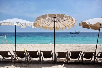 umbrellas and sun beds on the sandy beach.