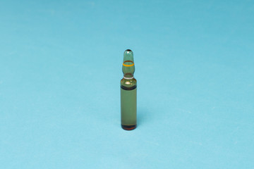 Vaccine ampoules on a blue background. Vaccine concept for children and adults against malaria,...