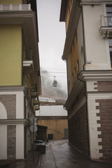 ski lift, between buildings.