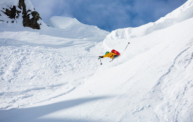 Naklejka na ściany i meble Skiing in the snowy mountains, good winter day.