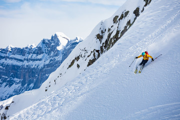Naklejka na ściany i meble Skiing in the snowy mountains, good winter day.