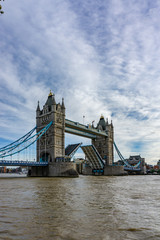Fototapeta na wymiar Tower Bridge on Thames river with the bridge open for ship traffic in London, UK