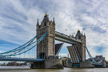 Fototapeta na wymiar Tower Bridge on Thames river with the bridge open for ship traffic in London, UK