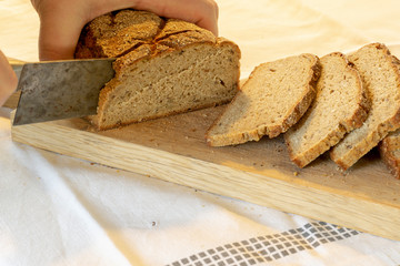 hands slicing home-made bread