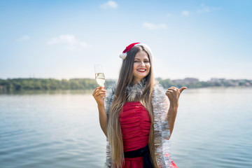 Attractive woman with long hair and champagne on beach
