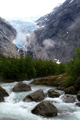 Melt water cascades down river fron Briksdal Glacier near Olden Norway