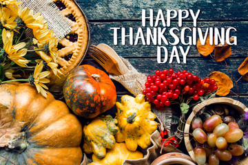 Happy Thanksgiving day text card - traditional holiday food with pumpkins on old wooden. 