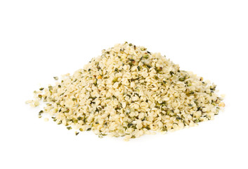 Heap of raw, organic hemp seeds over white