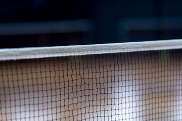 Badminton net indoor on badminton court, closeup view of badminton net with blurry background