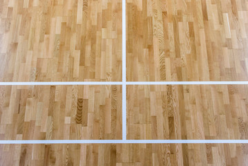 wooden floor badminton court and nets. Wooden floor of sports hall with marking lines line on...