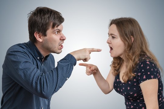 Young couple is arguing and blaming each other.