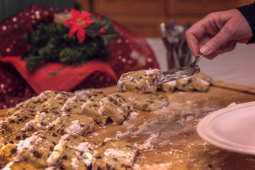 Someone in a restaurant or cafe at the delicious Christmas stollen. Stolle is a traditional Christmas pastry. Concept: baking or holidays
