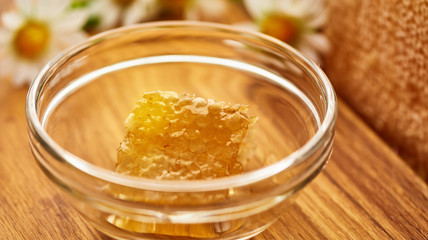 Honeycomb in glass bowl. Close-up of honey. Healthy organic. Sweet dessert background