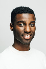 Portrait of a friendly young man, isolated on white studio background