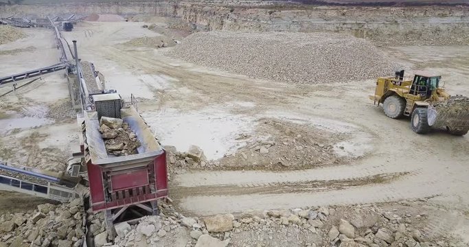 Aerial View of Bulldozer Unloading Limestone into Rock Crusher