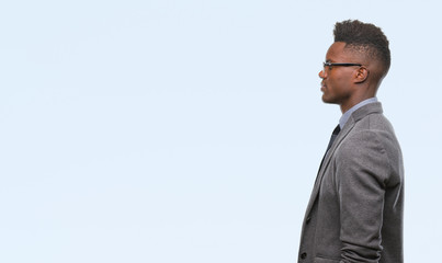 Young african american business man over isolated background looking to side, relax profile pose...