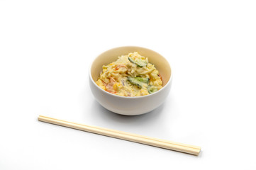 Japanese Potato Salad With Cucumbers, Carrots, and Onion isolated on the white and wooden chopsticks