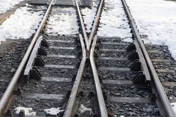 Fototapeta na wymiar Railway tracks and switch in winter with snow