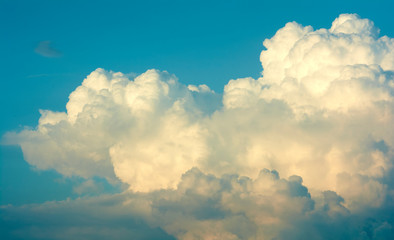 Blue sky with big clouds. Summer time of the year. Warm July evening. Nature photo for design. Outdoor stay