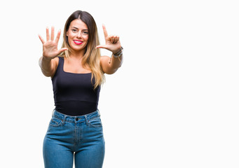 Naklejka na ściany i meble Young beautiful woman over isolated background showing and pointing up with fingers number seven while smiling confident and happy.