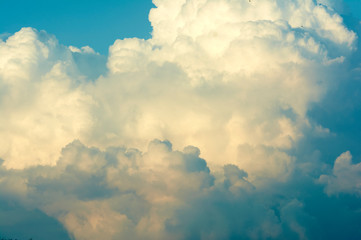 Blue sky with big clouds. Summer time of the year. Warm July evening. Nature photo for design. Outdoor stay