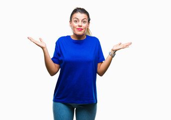 Young beautiful woman wearing casual blue t-shirt over isolated background clueless and confused...