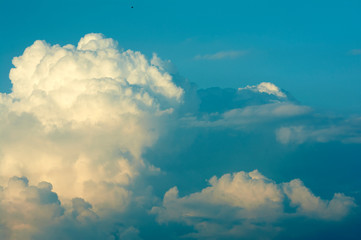 Blue sky with big clouds. Summer time of the year. Warm July evening. Nature photo for design. Outdoor stay