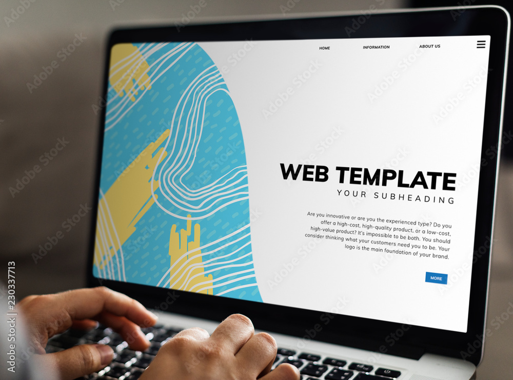 Wall mural working on a web template on the laptop