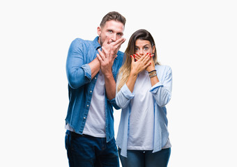 Young couple in love over isolated background shocked covering mouth with hands for mistake. Secret concept.