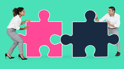 Colleagues connecting puzzle pieces