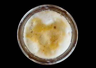 Top view of ice capuchino coffee in plastic glass isolated on black background.