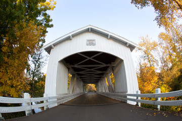 Fish eye center front perspective of Larwood covered bridge with fall color trees in a rural area in Oregon