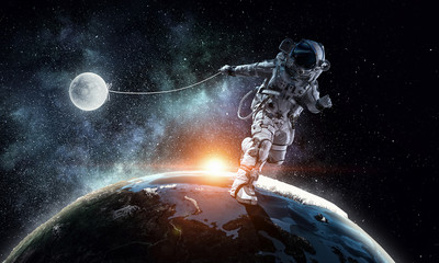 Obraz na płótnie Canvas Spaceman steal planet. Mixed media