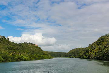 Fototapeta na wymiar river, forest on the banks and cloudy sky in the Dominican Republic