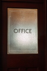 Office sign on door glass in art deco style. Could be found in America, Australia, England, Scotland or any other English speaking country