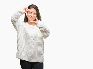 Young beautiful arab woman wearing winter sweater over isolated background smiling making frame with hands and fingers with happy face. Creativity and photography concept.