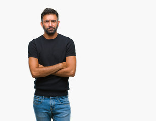 Fototapeta premium Adult hispanic man over isolated background skeptic and nervous, disapproving expression on face with crossed arms. Negative person.