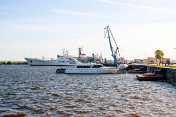 lighthouse, port of Kronstadt, ships at the pier