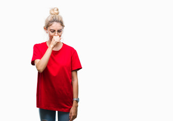Young beautiful blonde woman wearing red t-shirt and glasses over isolated background feeling unwell and coughing as symptom for cold or bronchitis. Healthcare concept.