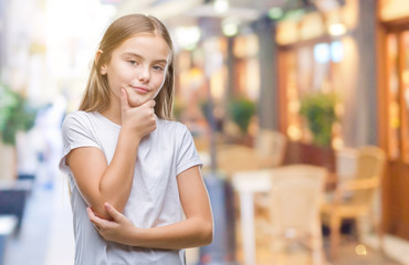 Young beautiful girl over isolated background looking confident at the camera with smile with crossed arms and hand raised on chin. Thinking positive.