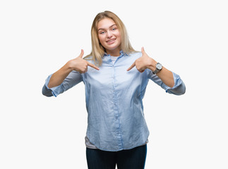 Obraz premium Young caucasian business woman over isolated background looking confident with smile on face, pointing oneself with fingers proud and happy.