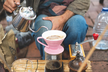 Barista making drift hot coffee in day market.
