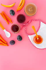 Ingredients for baby puree. Assortment of flavors of baby food. Vegetables and fruits. Apple, carrot, pumpkin, prune on pink background top view copy space