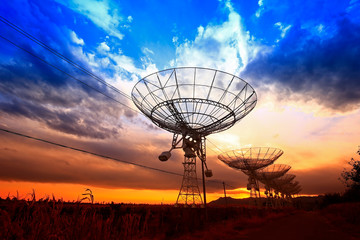 The silhouette of a radio telescope observatory