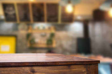 Selected focus empty brown wooden table and Coffee shop or restaurent blur background with bokeh image. for your photomontage or product display.