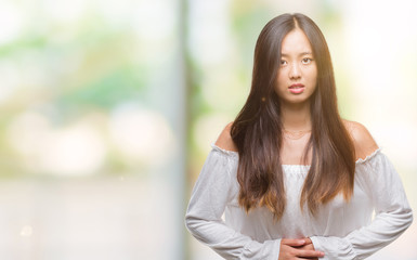 Fototapeta premium Young asian woman over isolated background with hand on stomach because indigestion, painful illness feeling unwell. Ache concept.