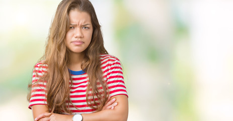 Young beautiful brunette woman wearing stripes t-shirt over isolated background skeptic and nervous, disapproving expression on face with crossed arms. Negative person.