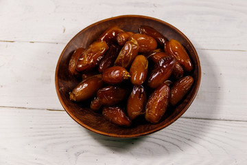 Dried dates fruit on white wooden table